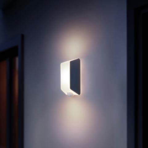 Steinel L 30 outdoor wall light providing warm ambient lighting in a modern indoor setting.