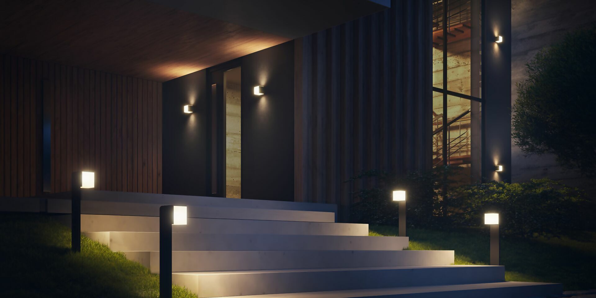 Modern building exterior with illuminated steps and lights at night