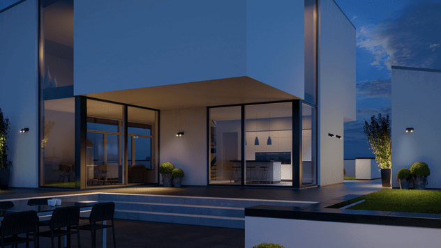 Modern house exterior illuminated by Steinel spot lights, showcasing security lighting features at dusk.